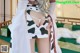 A woman in a cow print dress is posing for the camera.